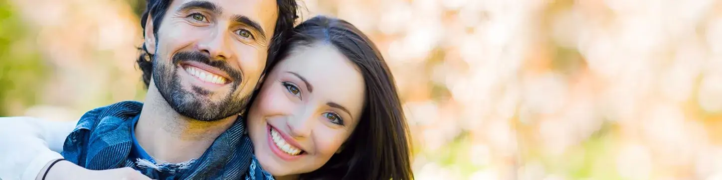 Couple smiling with bright, confident smiles after cosmetic dentistry at Denison Dental in Denison, Texas